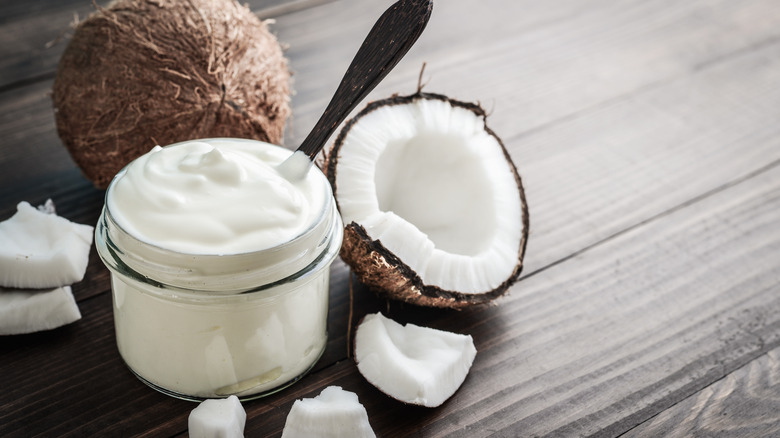 Coconut split open and jar of coconut cream