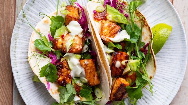 Salmon tacos with slaw and crema