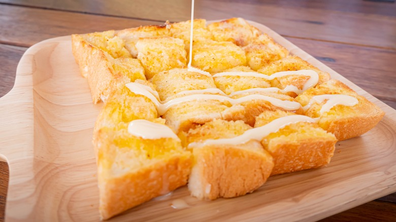 condensed milk toast on wooden dish