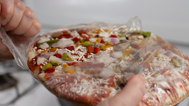 Unwrapping frozen pizza