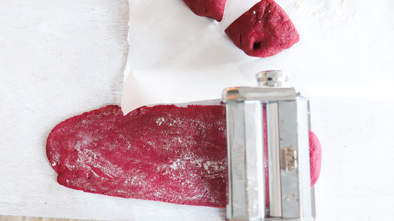 beet dough in pasta roller