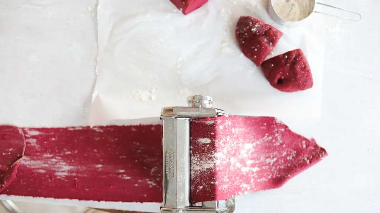 beet pasta dough in dough roller