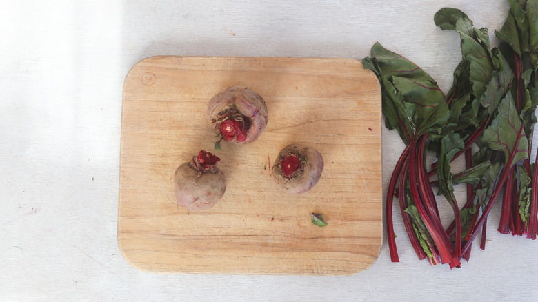 trimmed beets on cutting board