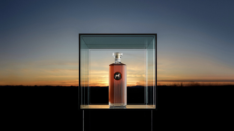 Bottle of SirDavis whisky at sunset