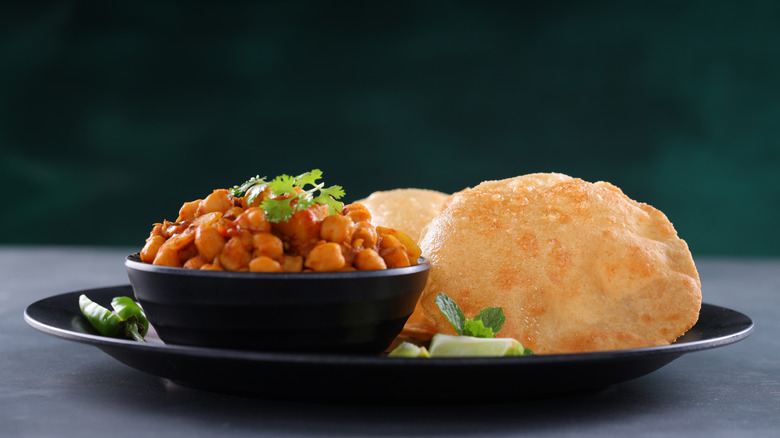 Chole bhature on a black plate