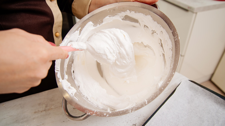 hands stirring meringue 