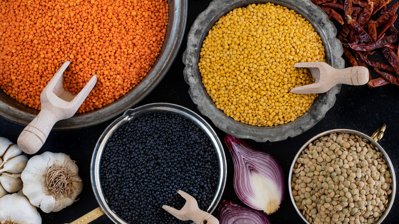 Several bowls of different types of lentils