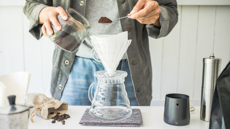 hands scooping coffee grounds