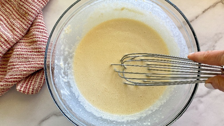 batter in glass bowl with whisk