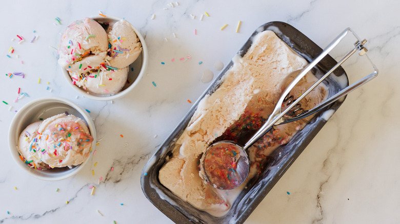 Two ice cream servings with large container