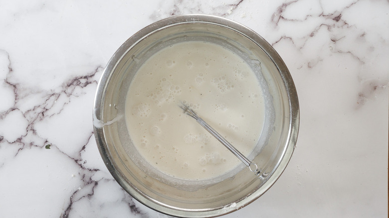 Ice cream mix in bowl with whisk