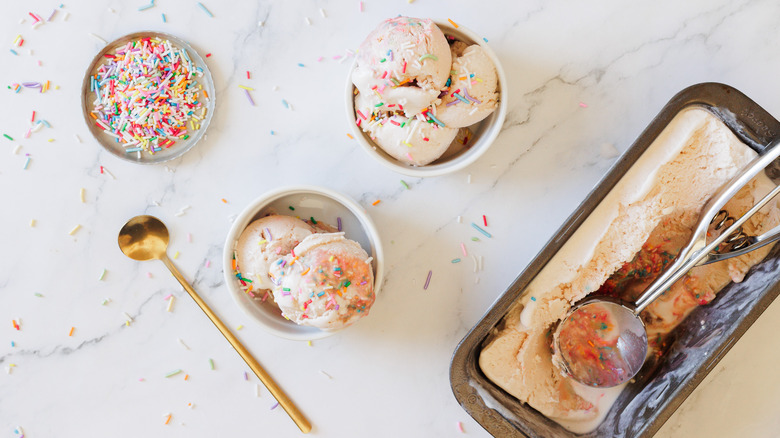 Two ice cream servings with large container