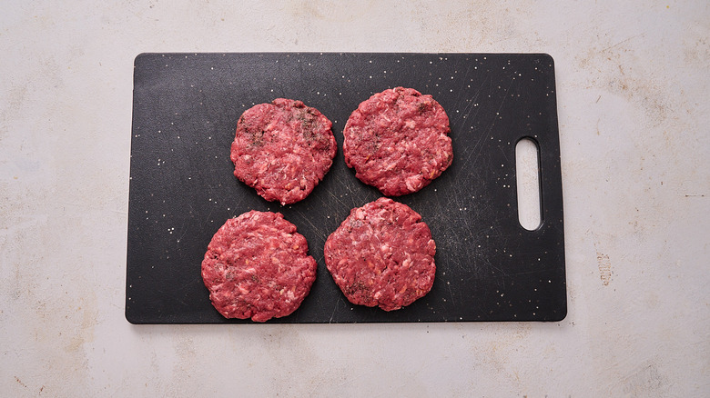 burger patties on cutting board