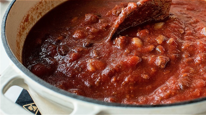 spoon stirring tomato sauce