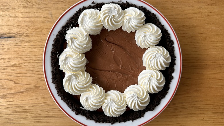 Chocolate pudding pie with whipped cream rosettes