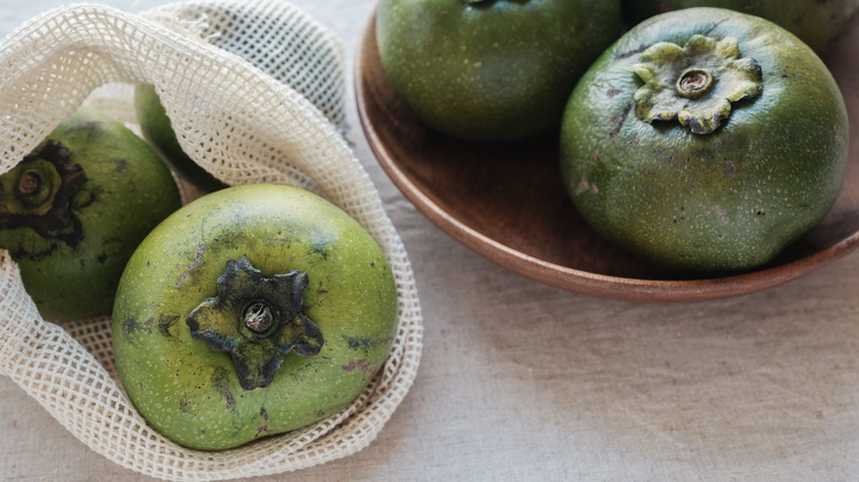 Black sapotes on counter