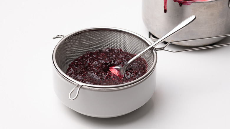 blackberry glaze being sieved 