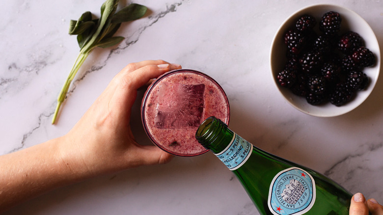 adding soda water to cocktail