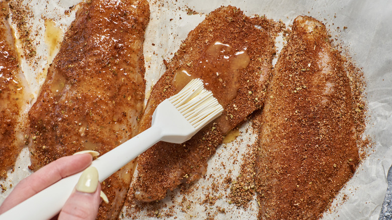 brushing butter on catfish