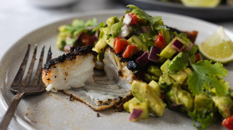 halibut with salsa on grey plate with fork