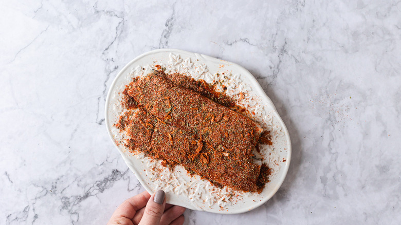 fish with spices on white plate