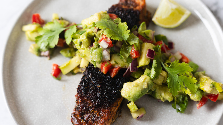 halibut with salsa on grey plate with lime