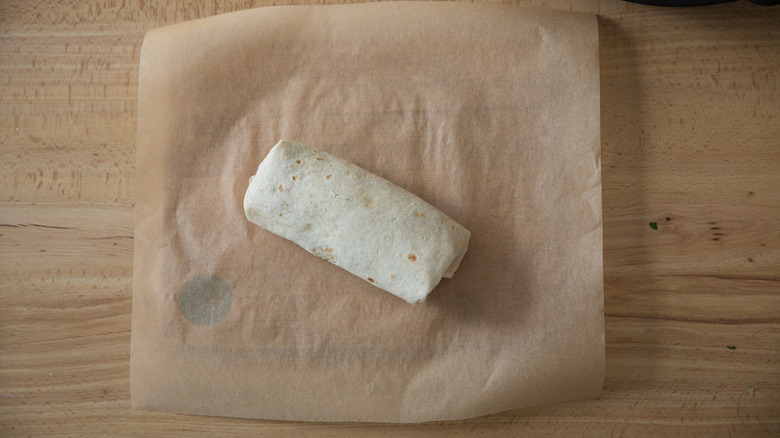 rolled burrito sitting on table 