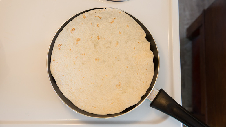 tortillas heating in frying pan 