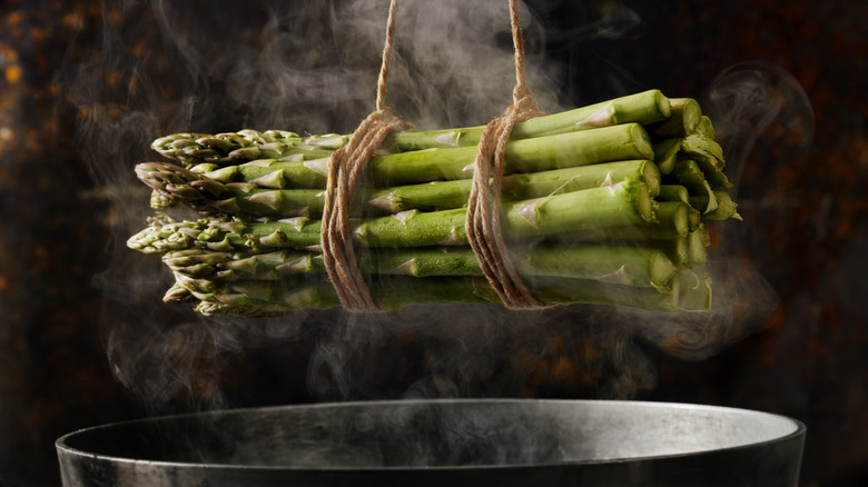 asparagus bundle over steaming pot