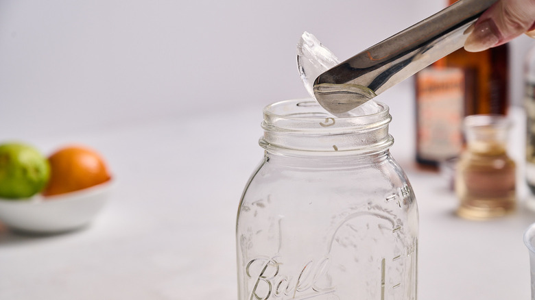 adding ice to cocktail shaker