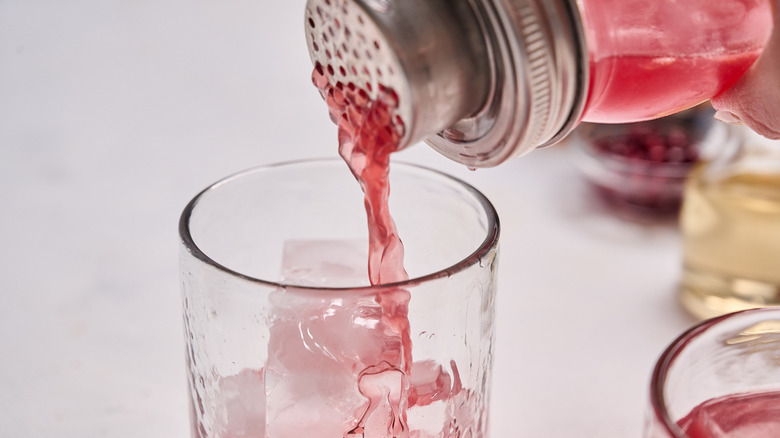 pouring cocktail into glass