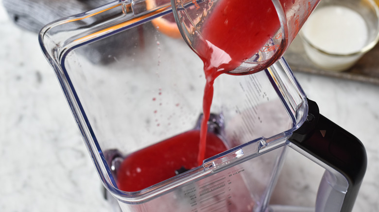 pouring blood orange juice into blender