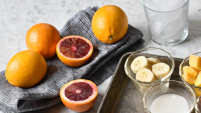 halved blood oranges for juicing on table