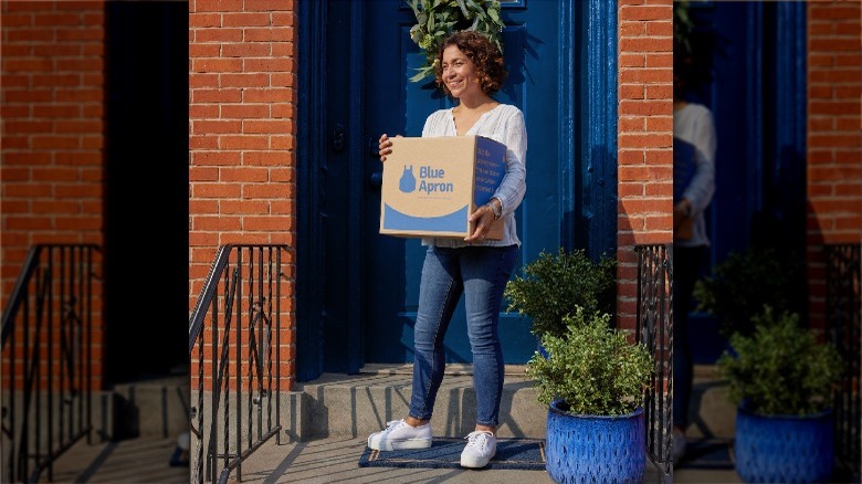 Person with Blue Apron box on porch