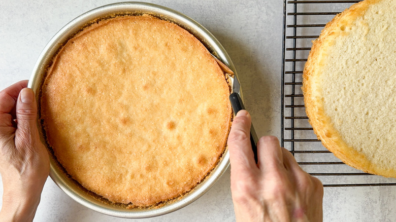 Loosening Chantilly cake layer from round cake pan with metal spatula