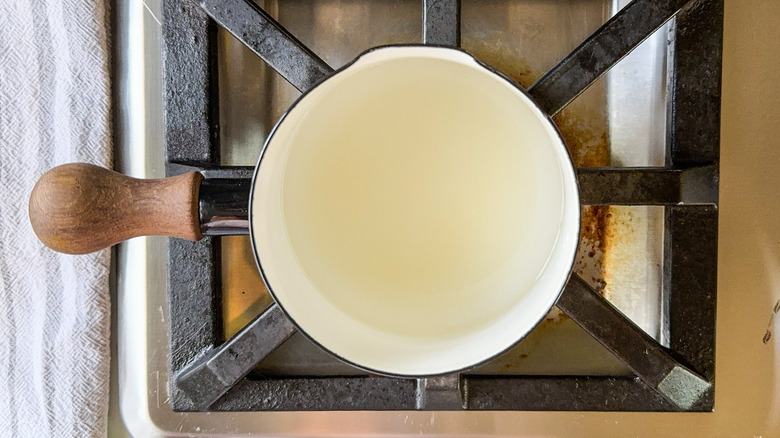 Almond simple syrup in saucepan on stovetop