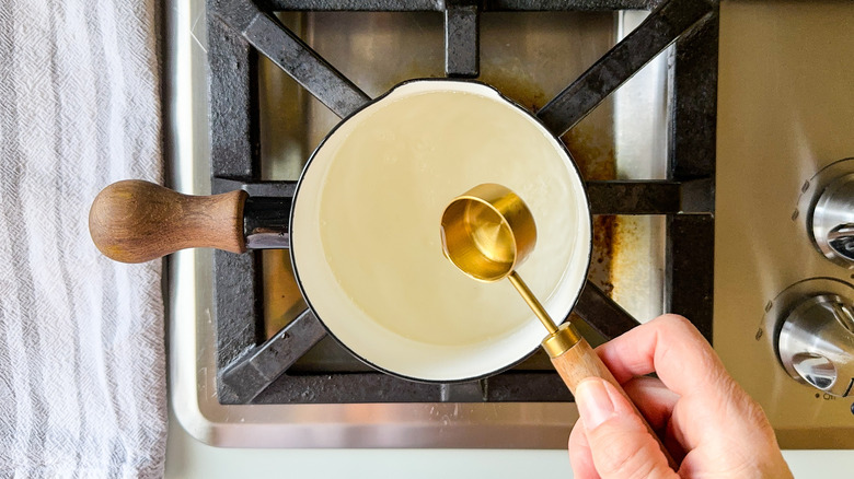 Adding almond extract to simple syrup in saucepan