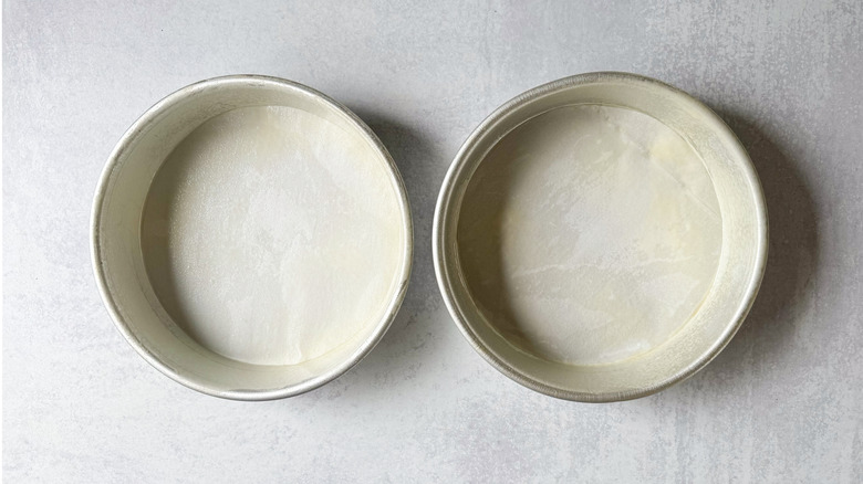 Round cake pans lined with parchment paper