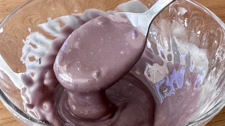 Lavender icing in bowl with spoon