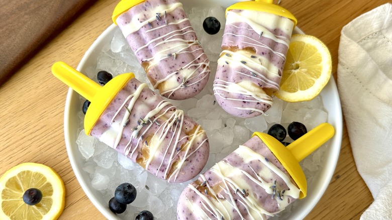 Blueberry-lavender honey popsicles served over ice