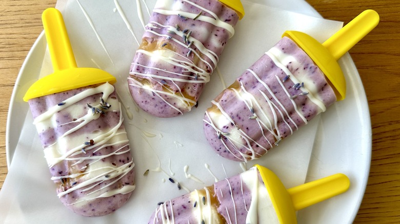 Blueberry-lavender honey popsicles on plate