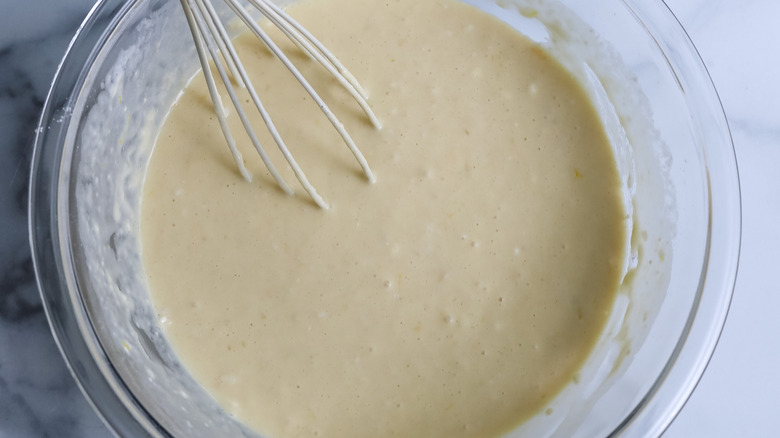 whisking popover batter in bowl