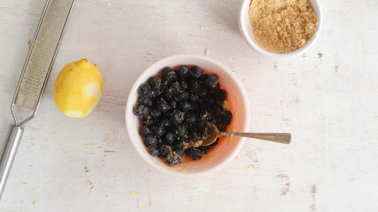 blueberries, lemon, and sugar in a bowl