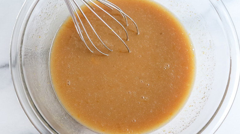 wet ingredients in a bowl with a whisk