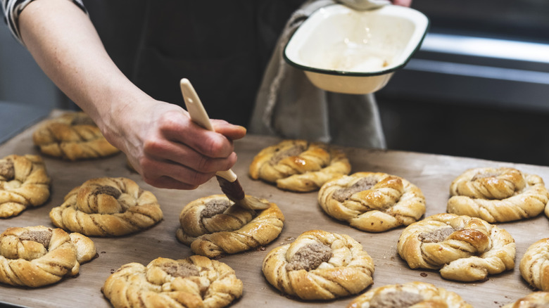 Brushing a wash on a pastries