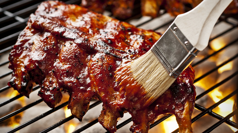 barbecue sauce brushed over baby back ribs