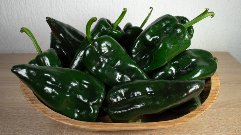 Poblano peppers in a wooden bowl