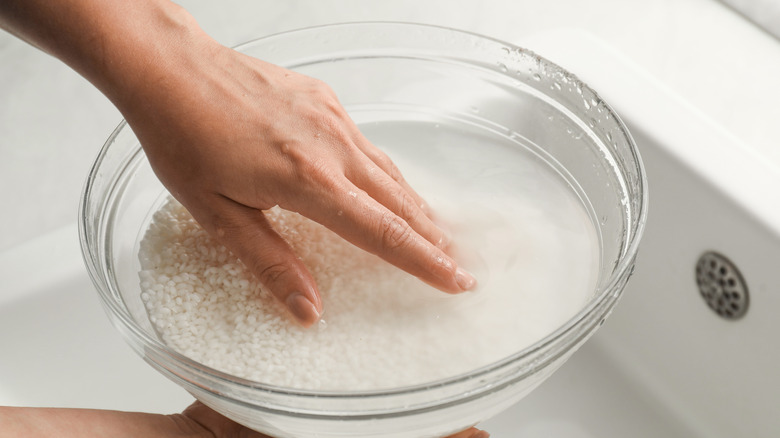 Rice being rinsed in a bowl