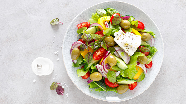 Salt shaker next to a salad