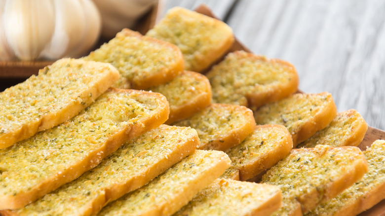 Slices of homemade garlic bread placed on top of each other
